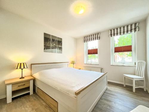 Postel nebo postele na pokoji v ubytování Sünnslag Wohnung 099
