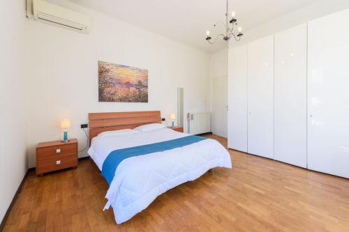 a bedroom with a bed and a painting on the wall at Golden Luxe - Roman Luxury Villa in the Sea in Camaiore