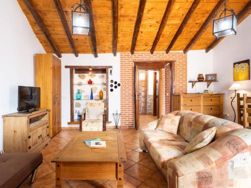 a living room with a couch and a coffee table at Live Arico El Cortijo Casa Rural con Solarium y Terraza in Arico Viejo