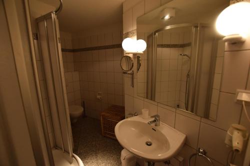 a bathroom with a sink and a toilet and a mirror at Friesenhof, fr 02 in Rantum