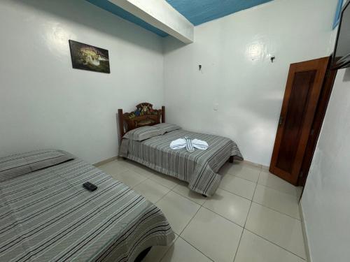 a bedroom with two beds in a room at Pousada Vilasboas in Parintins