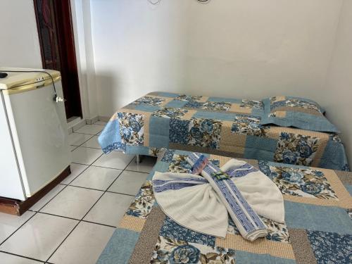 two beds sitting next to each other in a room at Pousada Vilasboas in Parintins