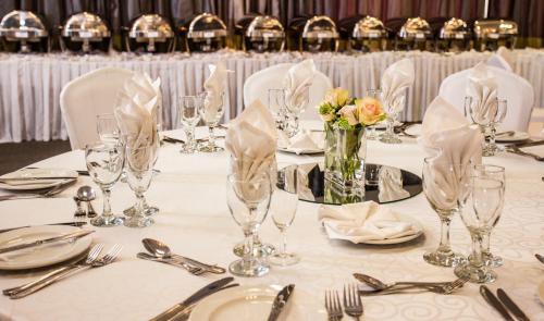 a table set for a wedding with glasses and flowers at Coastlands Musgrave Hotel in Durban