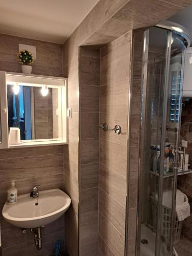 a bathroom with a sink and a shower at Holiday Home Adricon in Grižane
