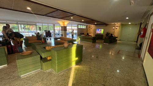 a lobby with green furniture in a building at Gran Solare Flat Residence - Mandacaru 505 in Barreirinhas