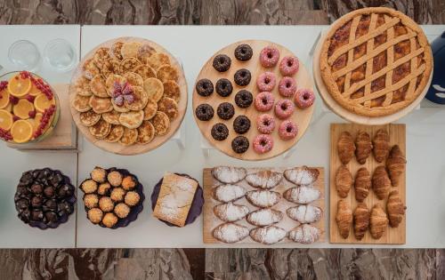a table topped with plates of different types of pastries at Hotel Universal in Cattolica
