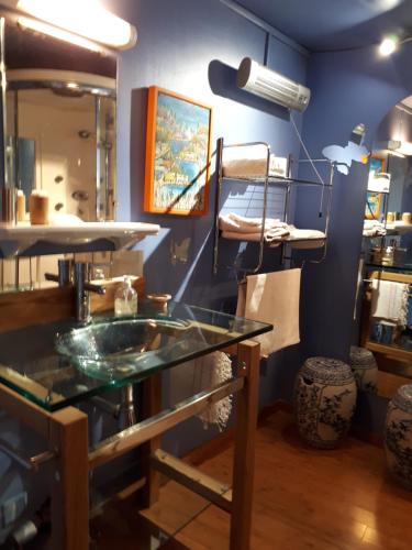 a bathroom with a glass counter top in a room at Chambre d'Hôte Le Théron in Dieulefit
