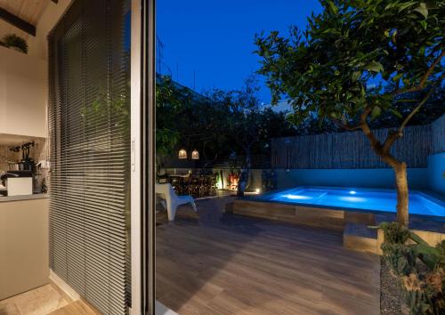 a pool in the backyard of a house at night at City Cottage - Kalamata Villas in Kalamata