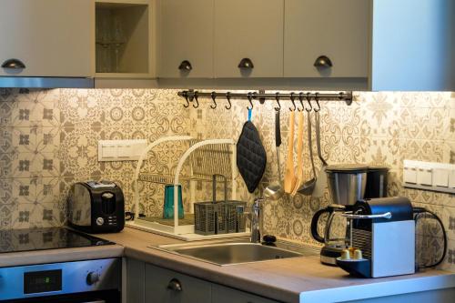 a kitchen with a sink and a counter top at City Cottage - Kalamata Villas in Kalamata