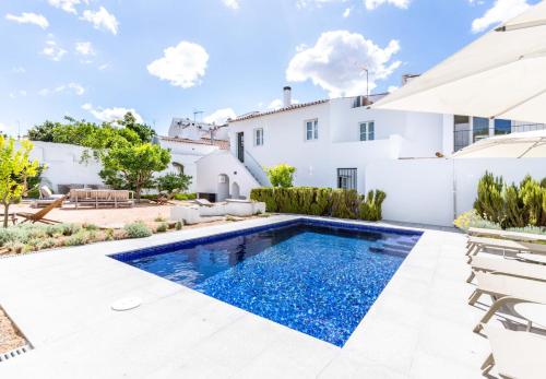 a swimming pool in the backyard of a villa at Limehome Evora Rua de Machede 52 in Évora