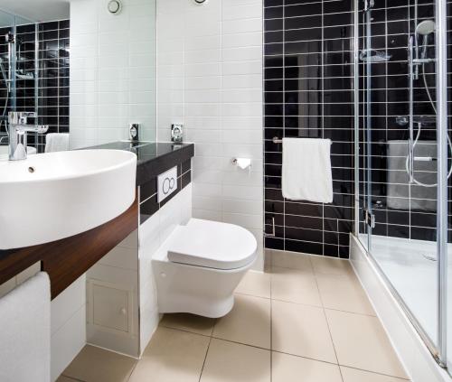 a bathroom with a toilet and a sink and a shower at Holiday Inn Express London - ExCel, an IHG Hotel in London