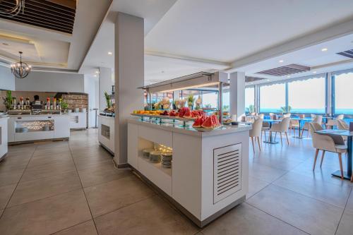 a kitchen with a counter with food on it at Adora Calma Beach Hotel Adults Only in Kızılot