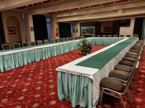 a long table in a conference room with chairs at Apollonia Hotel Gevgelija in Gevgelija