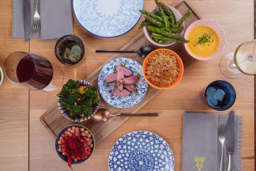 a wooden table with plates of food on it at Hotel Blü Gastein in Bad Hofgastein