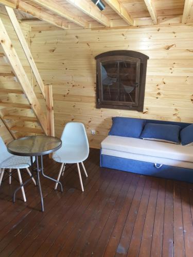 a room with a bed and a table and chairs at Dom Pod Dębami in Wola Kopcowa
