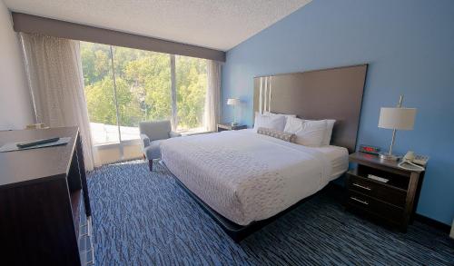 a hotel room with a bed and a large window at Glenstone Lodge in Gatlinburg
