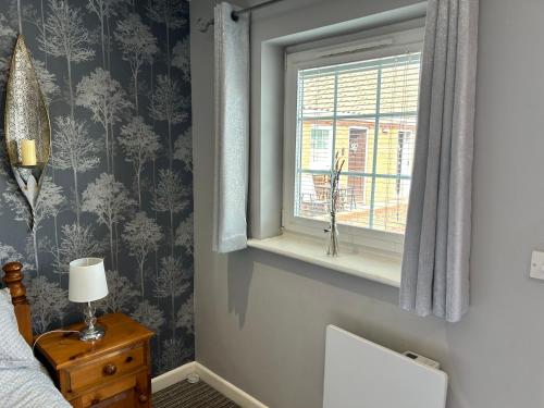 a bedroom with a window and a bed and a desk at Angel Inn Misson in Misson