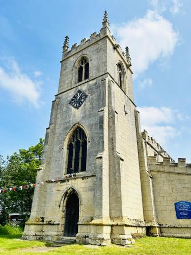 a clock tower on the side of a church at Angel Inn Misson in Misson