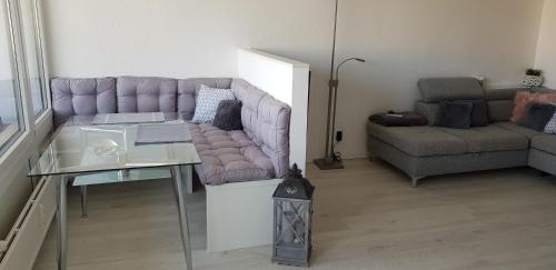 a living room with a couch and a table at Ferienwohnungen Fuchs in Duisburg