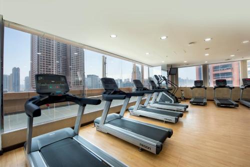 a gym with a row of treadmills in a building at Two Seasons Hotel & Apartments in Dubai