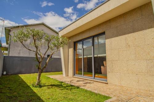 a house with a tree in front of it at Casa do Douro& Porto in Lousada