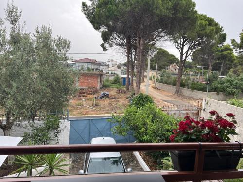 a balcony with a view of a pool and flowers at Mone luxury villa in Vlorë