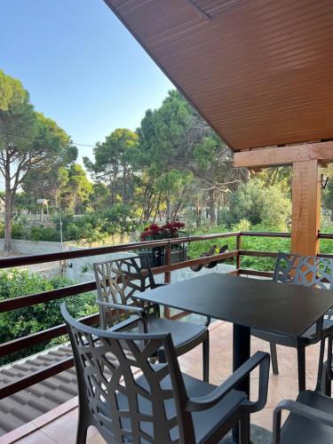 a table and chairs on a balcony with a view of a river at Mone luxury villa in Vlorë