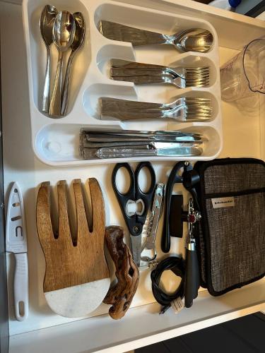 a drawer filled with utensils on a shelf at Thetis Island Get Away Cottage in North Galiano