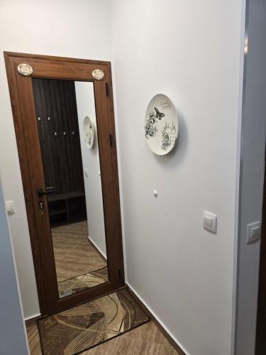 a mirror hanging on a wall next to a door at Апартамент Морската Къща-НЕСТИНАРКА in Tsarevo