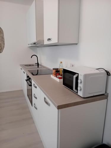 a microwave sitting on a counter in a kitchen at Piazza Roma apartment next como lake and station by revenue house in Como
