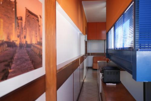 a hallway with a desk and a tv on a wall at Comprensorio Olivetti - La Serra - stanza 204 in Ivrea