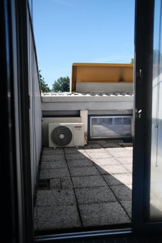 a view from a window of a house with a microwave at Comprensorio Olivetti - La Serra - stanza 204 in Ivrea
