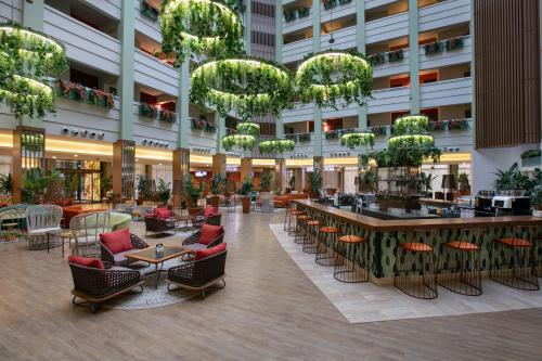an empty lobby of a hotel with chairs and tables at Megasaray Resort Side in Side