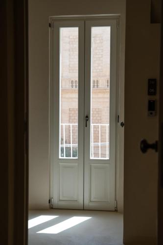 an open door with two windows in a room at NEW OPENING - Palazzo Gasparino Suites in Monopoli