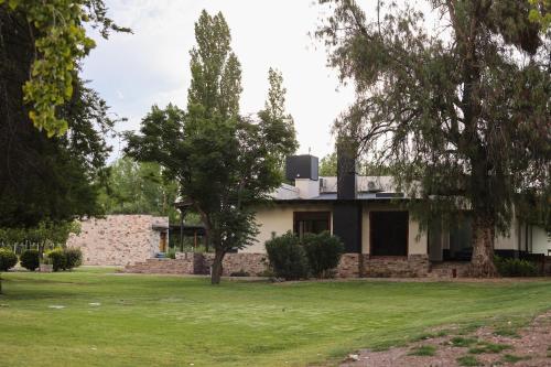 a house with a stone wall and trees at Algodon Wine Estates & Champions Club in San Rafael