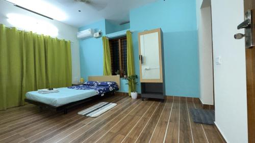 a hospital room with a bed and a mirror at Alchemist Villa-Kazhakootam in Trivandrum