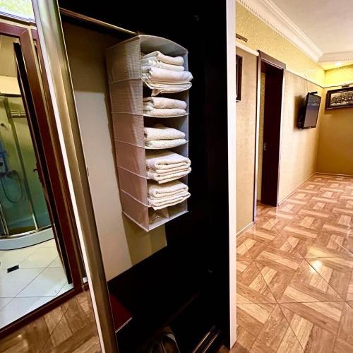 two pictures of a towel rack in a hotel room at Apartment Orbi Sea Tower David in Batumi