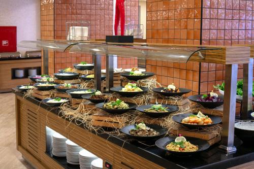a buffet line with plates of food on display at Megasaray Resort Side in Side