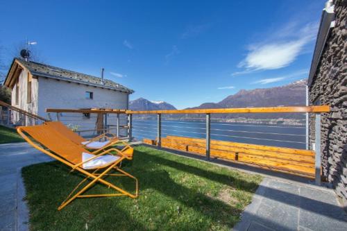 a yellow chair sitting on the grass on a balcony at Paradiso del lago in Bellano