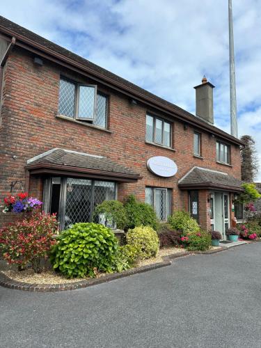 a brick house with flowers in front of it at Ardawn House in Galway