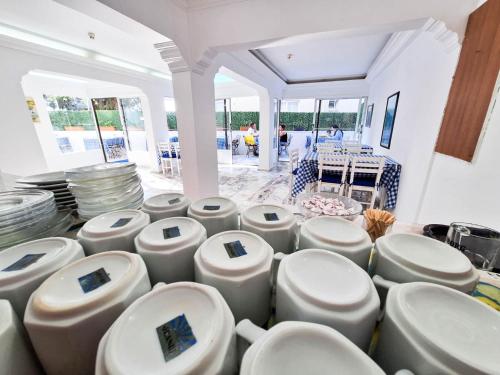 a bunch of white toilets in a room at Golden Beach Hotel in Didim