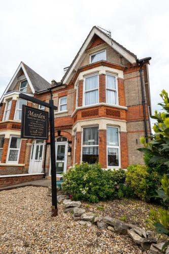 a house with a sign in front of it at Marden guest house in Weymouth