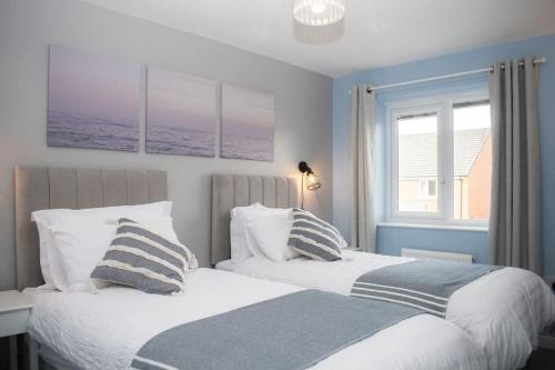 a bedroom with two beds and a window at Comfy Modern 3BR Semi Detached 400Mb Wifi Free Double Parking in Kenton