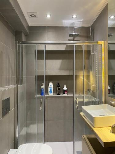 a bathroom with a shower and a sink at M+V apartment in Alexandroupoli