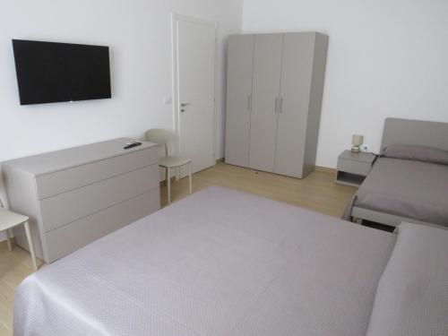 a bedroom with a bed and a dresser and a tv at Morfeo appartamenti e camere in Palmi