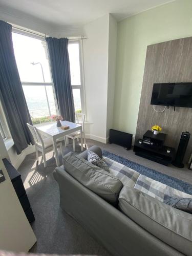 a living room with a couch and a table at Farina Holiday apartments in Bridlington
