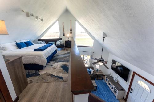 a bedroom with a bed and a television in a attic at Fun House #265 w Water Park & Golf Cart in Arnolds Park
