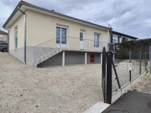 a house with a staircase in front of it at Chez CHARLETTE in Les Malots