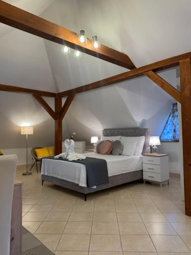 a bedroom with a large bed in a attic at STYLISH STUDIO APARTMENT BURE in Murter