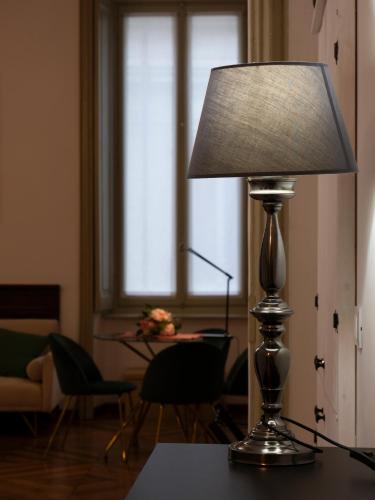a lamp sitting on a table in a living room at Mercanti e Viaggiatori in Turin
